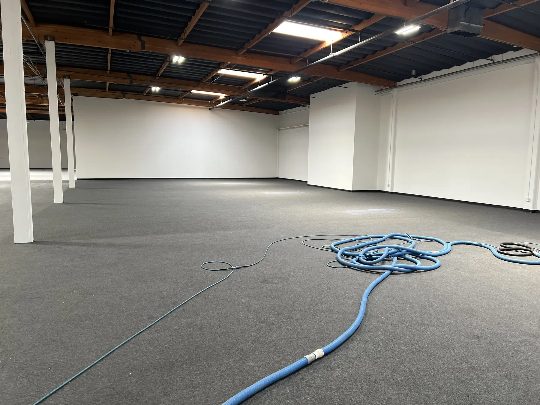 Professional carpet cleaning equipment across a large interior space